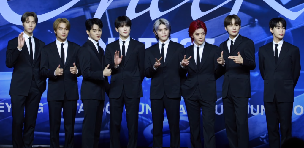 NCT 127 members together at the Fact Check press conference in October 2023