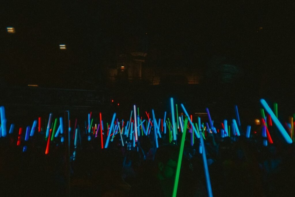 A sea of glowing white lights at a concert, illustrating H.O.T. fandom culture