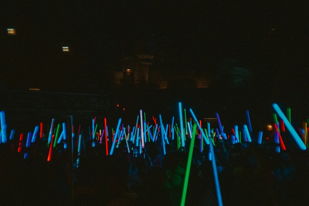 A sea of glowing white lights at a concert, illustrating H.O.T. fandom culture