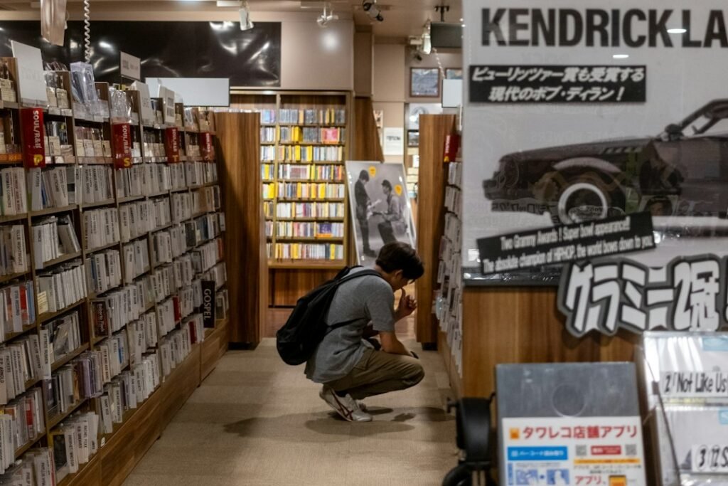 A shopper browsing physical music in a record store, illustrating Japan's strong album-buying culture