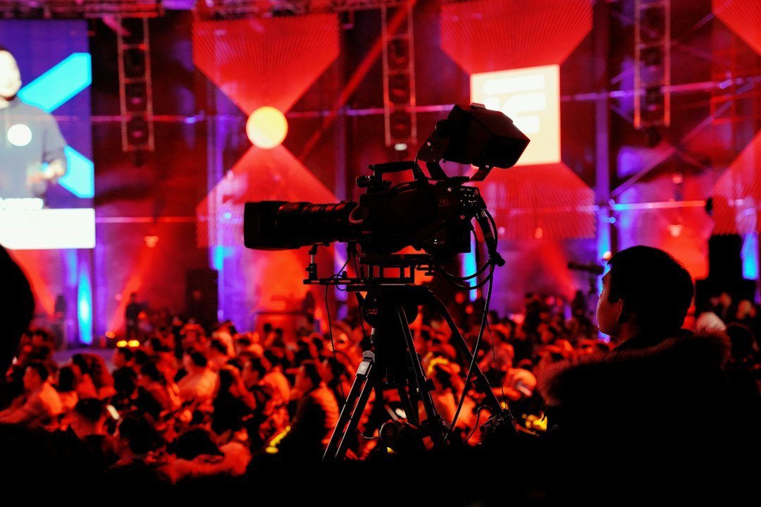 Broadcast camera inside a studio, illustrating K-pop music show recording