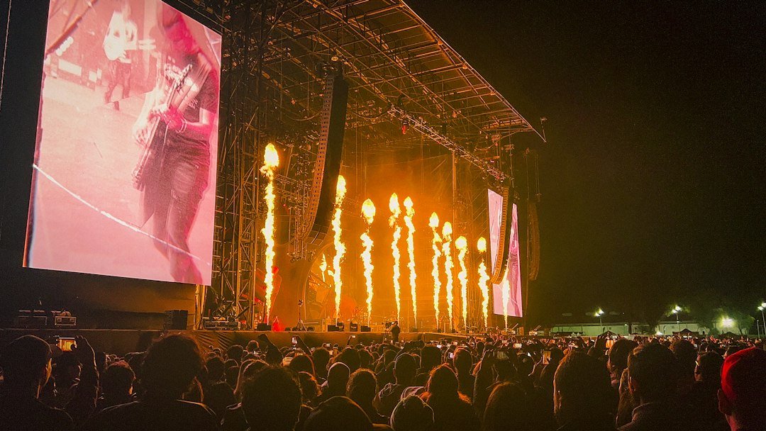 Crowd watching a large concert screen, illustrating K-pop's stadium-scale growth in Mexico