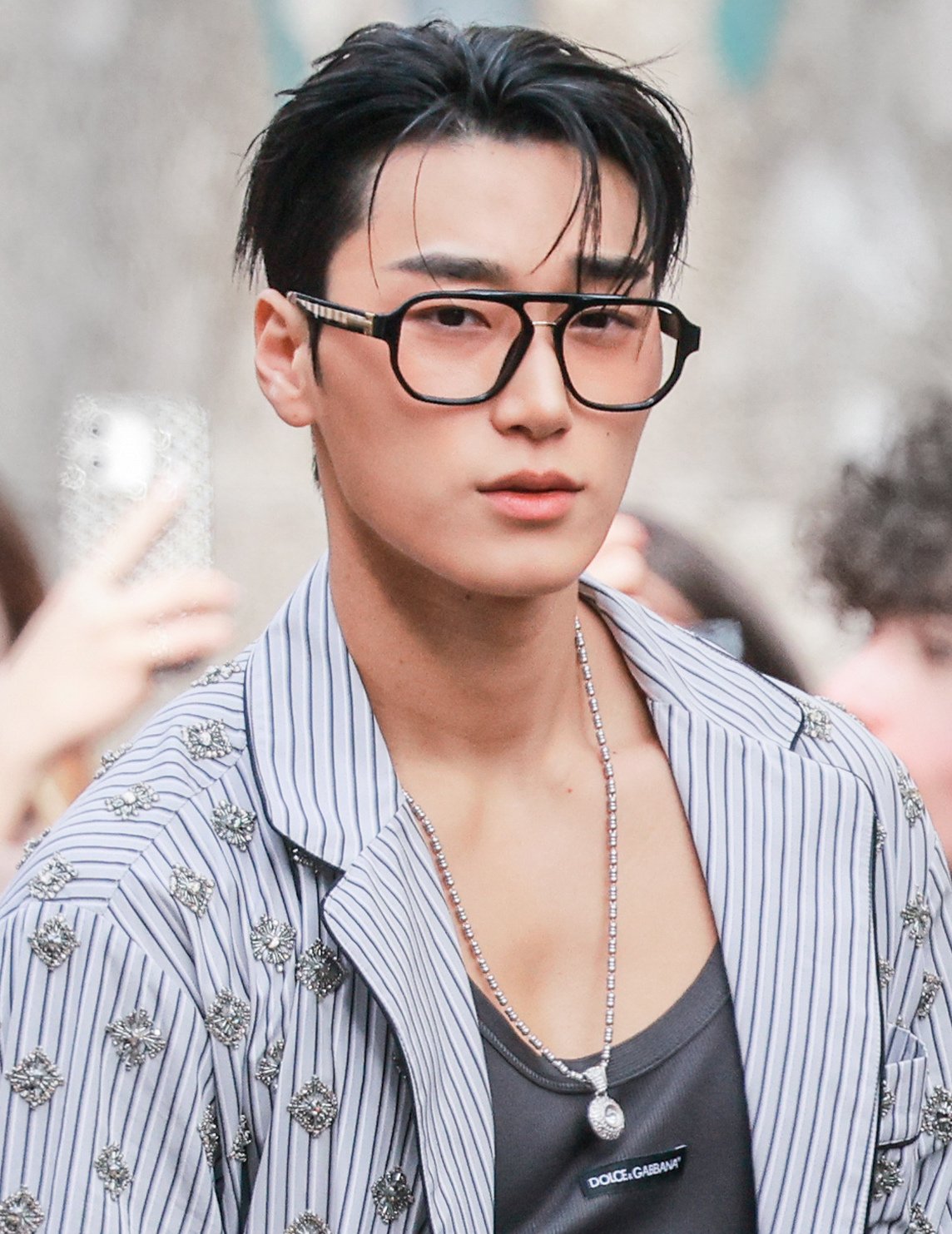 ATEEZ member San attending a 2026 fashion show, archival portrait