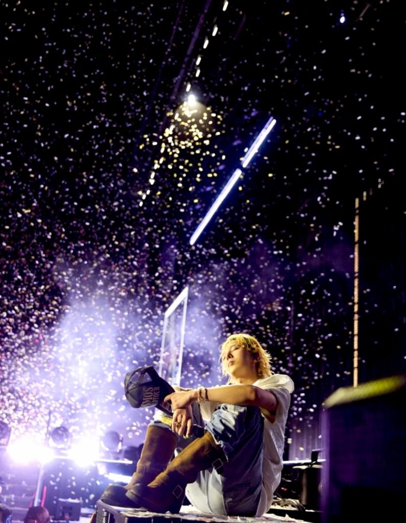 G-DRAGON seated on stage during a concert, from his official Instagram