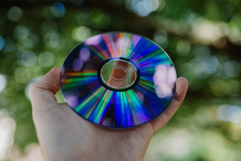 Person holding a compact disc, illustrating the renewed collectible appeal of CDs in the U.S. music market